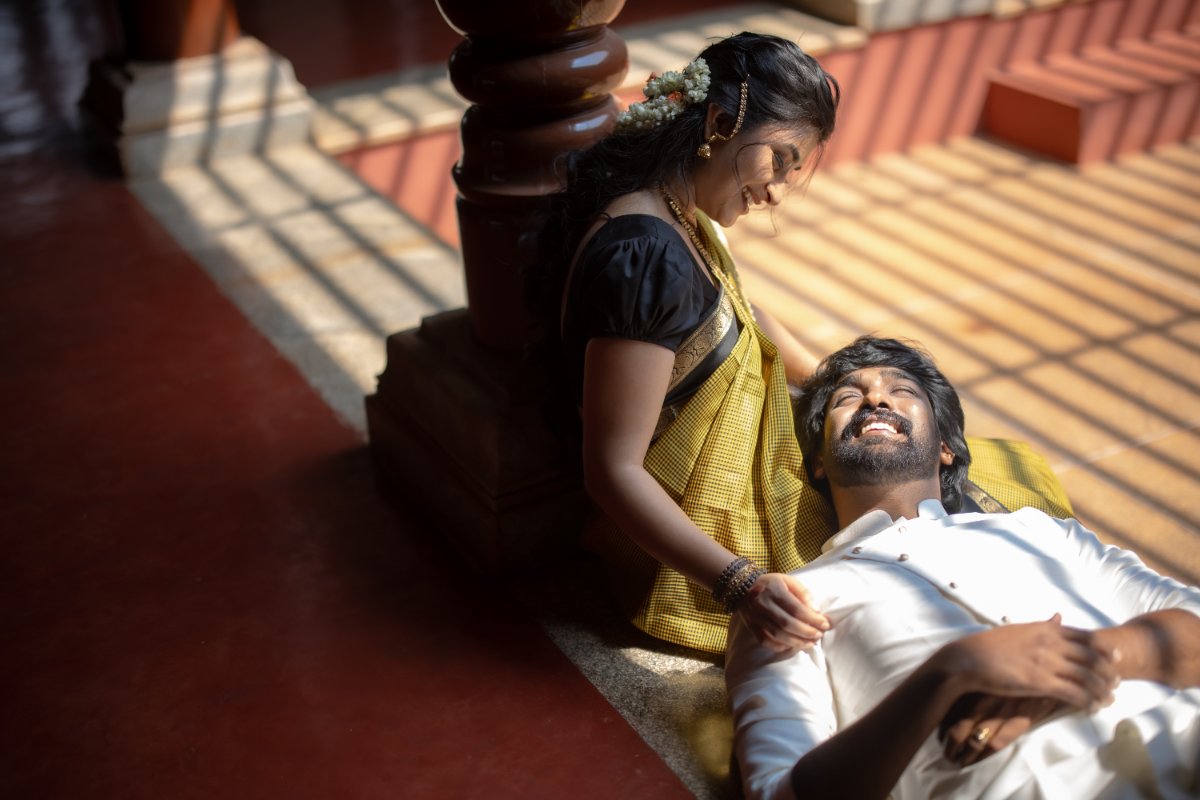 Pre-wedding couple shoot by WeddingClickz — late-afternoon light through a colonnade