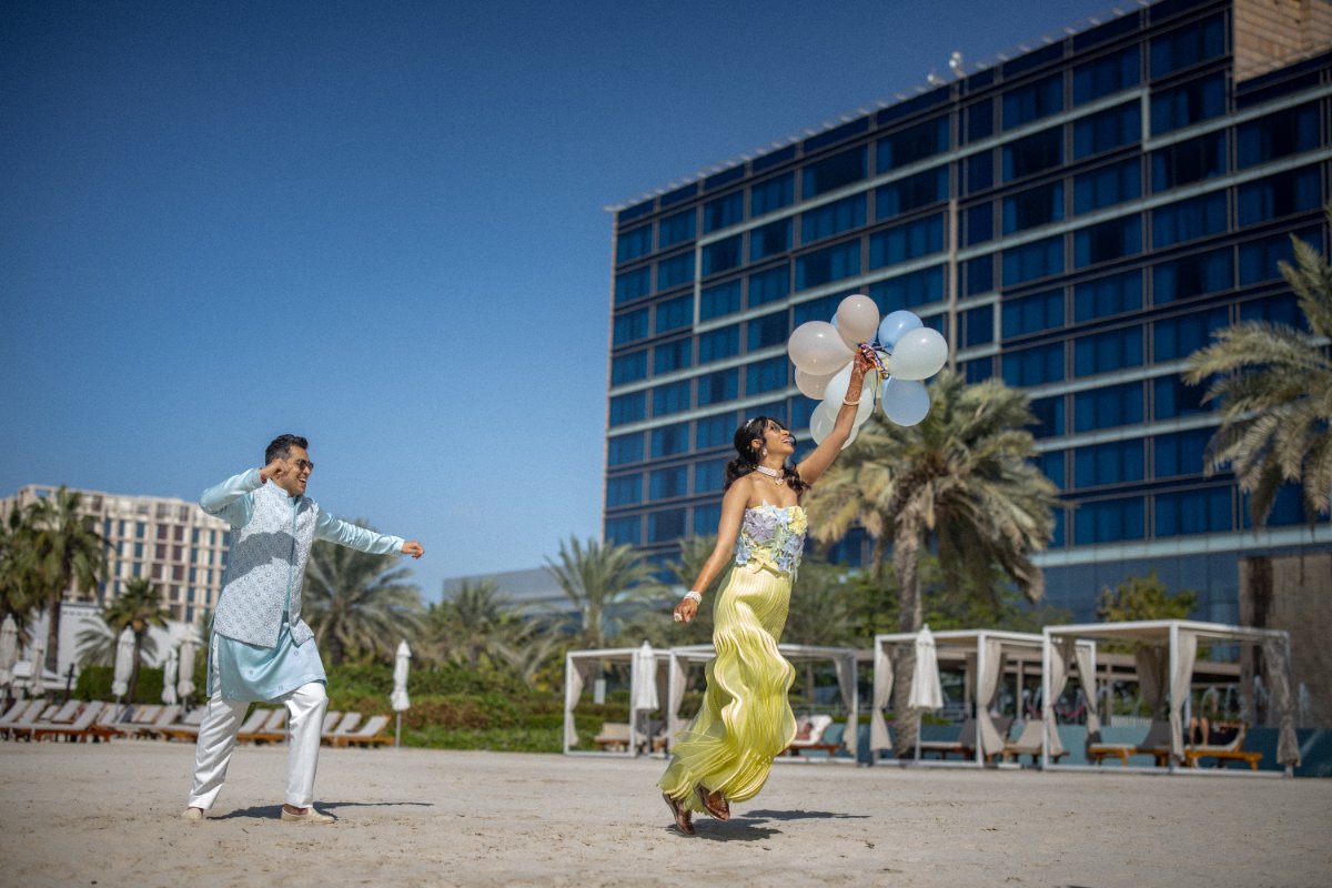 Pre-wedding couple shoot by WeddingClickz — balloons, and a couple not taking it too seriously